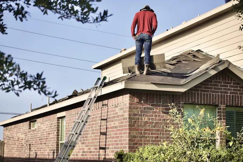 Professional roofer working on a residential roof in Colonial Manor